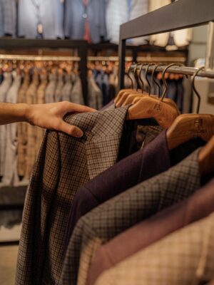 Close-up of elegant men's jackets on display in a modern boutique. Perfect for autumn fashion.