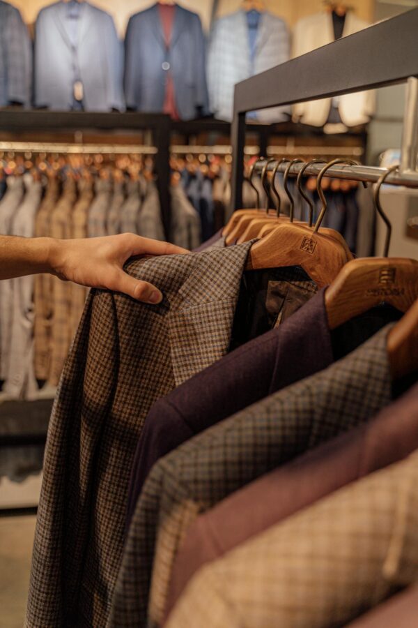 Close-up of elegant men's jackets on display in a modern boutique. Perfect for autumn fashion.